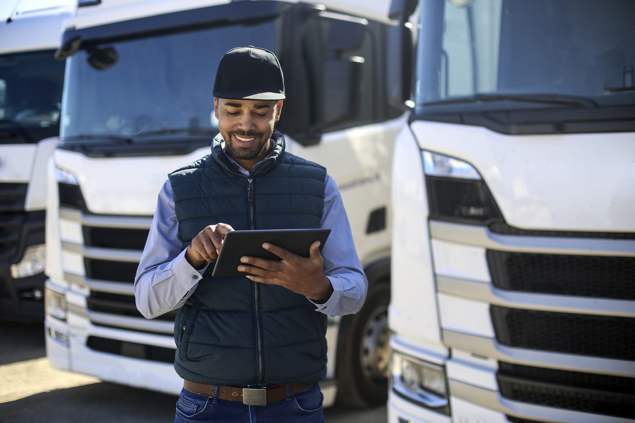 Truck driver using a tablet. About 35 years old, African male.